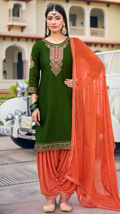 Woman in green and orange traditional outfit with vintage car in background